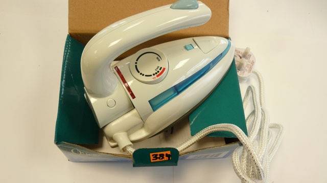Dual voltage travel iron folding handle